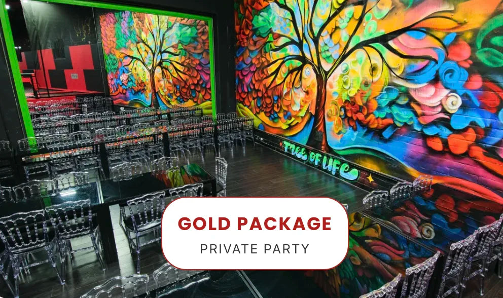 A vibrant, colorful room with a large mural of a tree on the wall, clear acrylic chairs arranged in rows, and a sign in front reading 